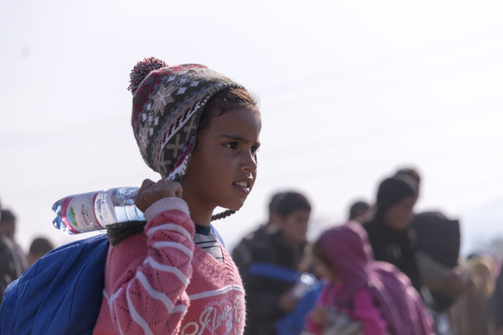 refugee-child-with-a-backpack-and-a-bottle-of-water-000077509471_full