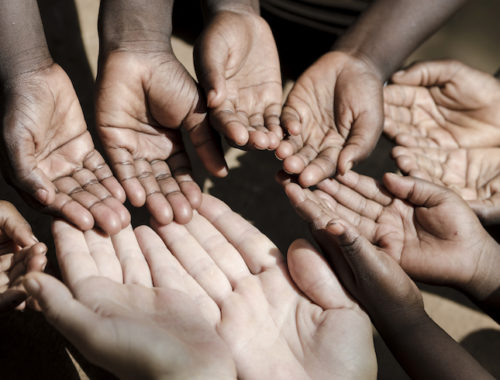 caucasian-and-african-ethnicity-hands-asking-for-help-symbol-000075426457_large