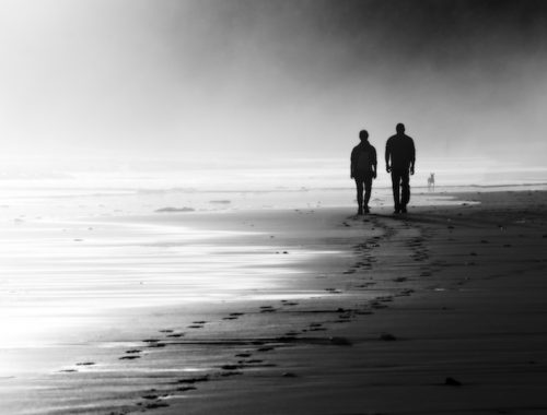 couple-walking-on-foggy-beach-000056327330_large