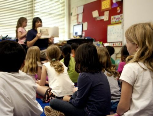 typical-classroom-scene-where-an-audience-of-school-children-were-seated-on-the-floor-725x482
