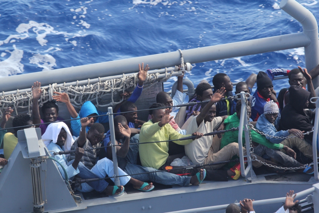 distressed_persons_wave_after_being_transferred_to_a_maltese_patrol_vessel