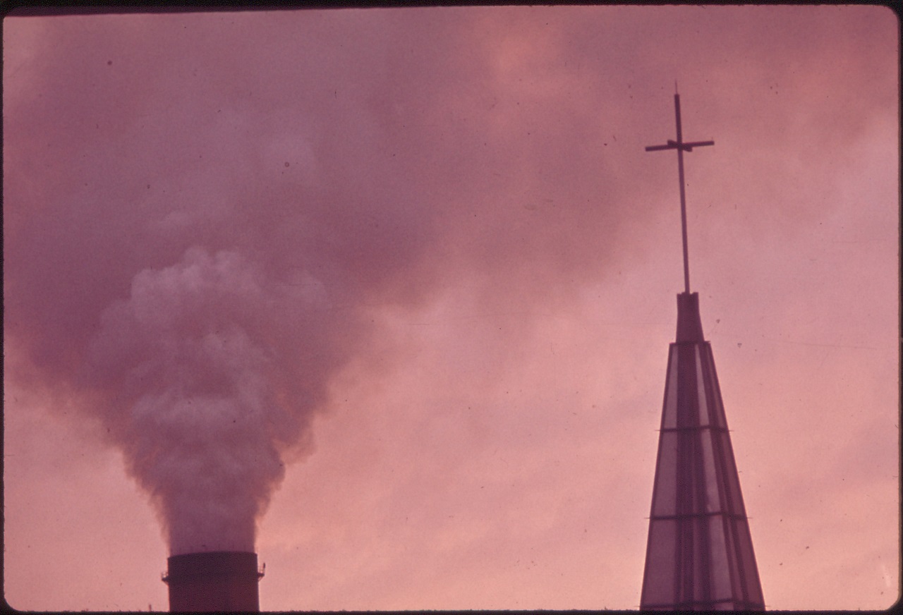 the_kaiser_aluminum_plant_smokestack_behind_the_catholic_church_belches_fumes_over_the_residential_area_in_the