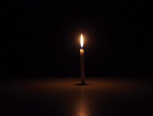 single-candle-in-dark-background
